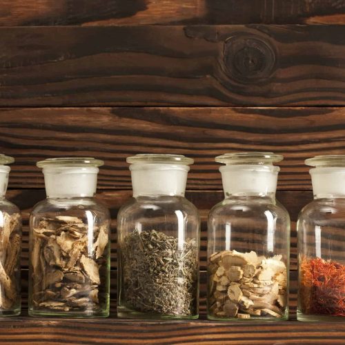 Various Chinese medical herbs in glass bottles