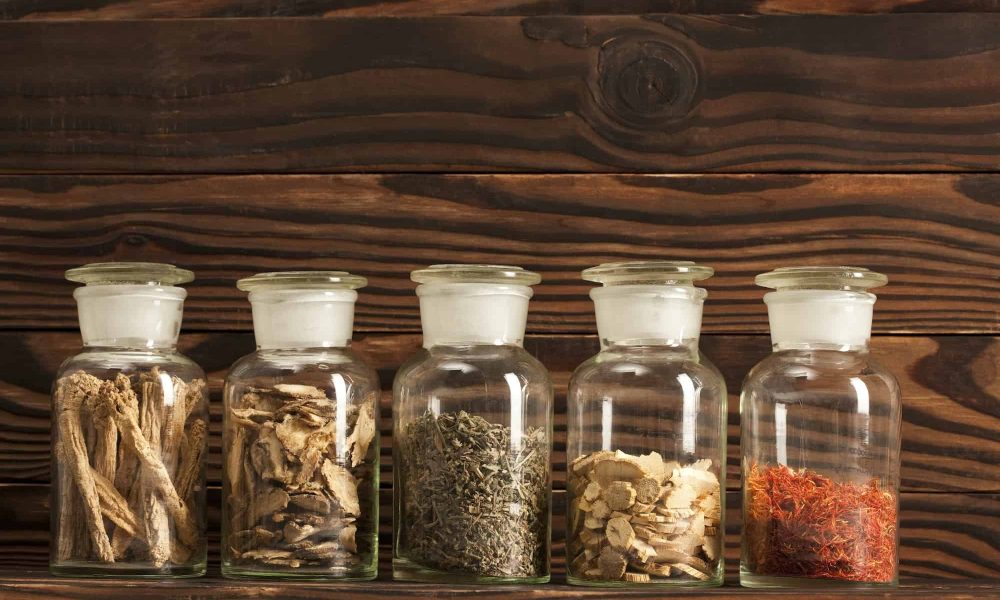 Various Chinese medical herbs in glass bottles